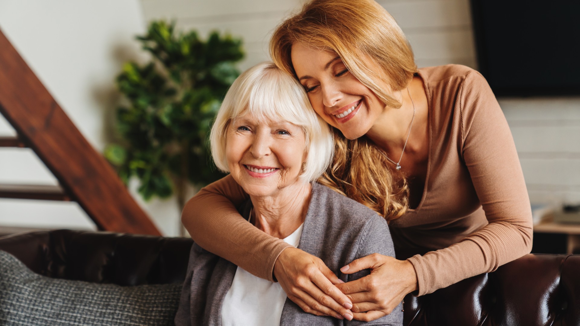 A caregiver gently hugging a senior resident