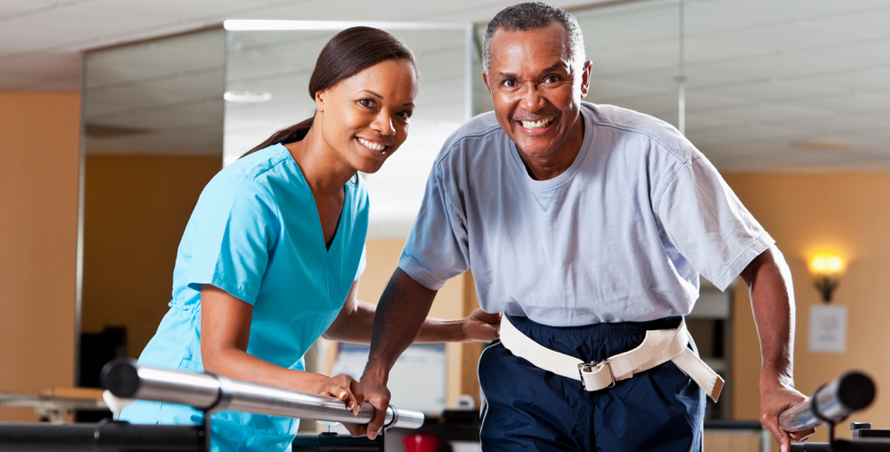 A resident and staff member engaging in physical therapy