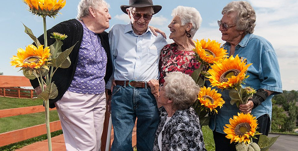 Residents outdoors holding sunflowers