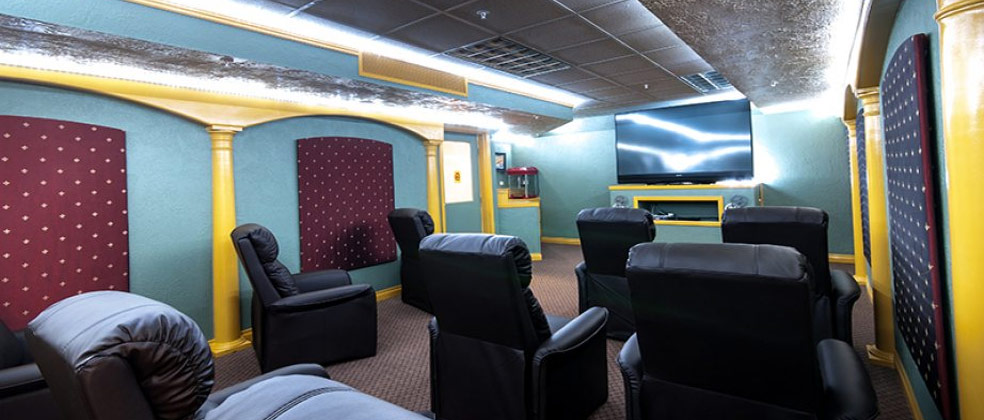Cozy common area with reclining chairs and large TV