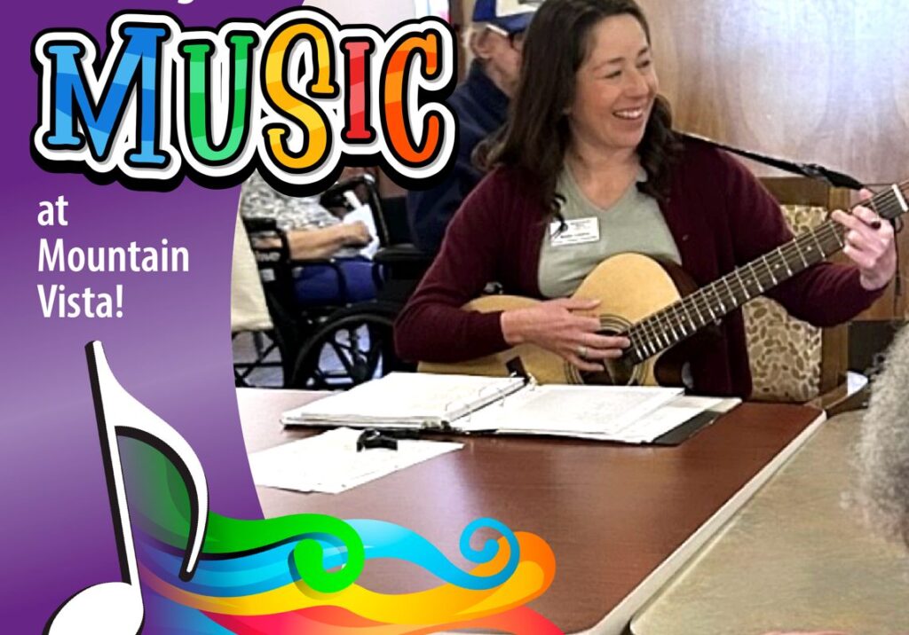 A staff member playing guitar during a music activity