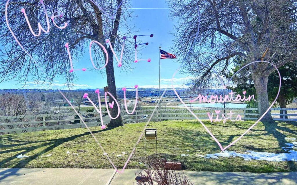 View of an outdoor space with a flag and heartfelt message.