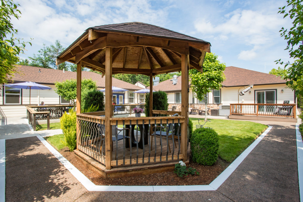 Wooden gazebo in landscaped outdoor area