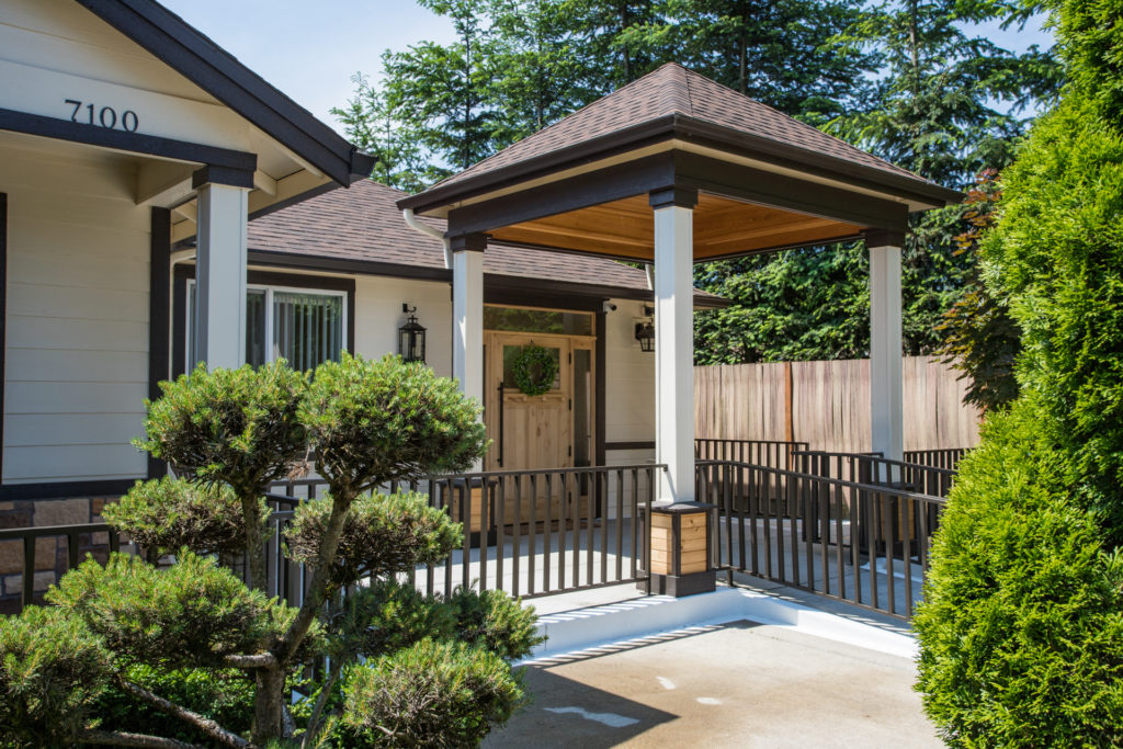 Entrance area with covered porch and garden