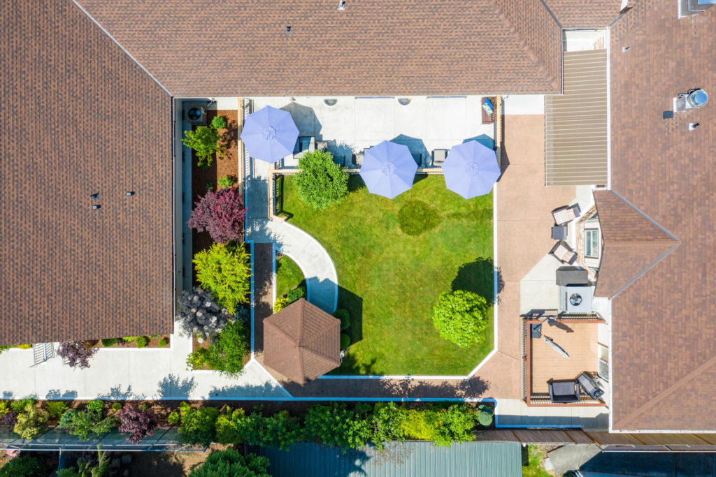Aerial view of a landscaped outdoor area with umbrellas.