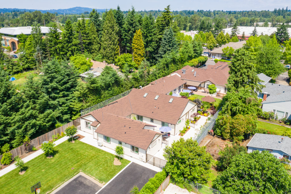 Aerial view of Mapleview Manor surrounded by greenery.
