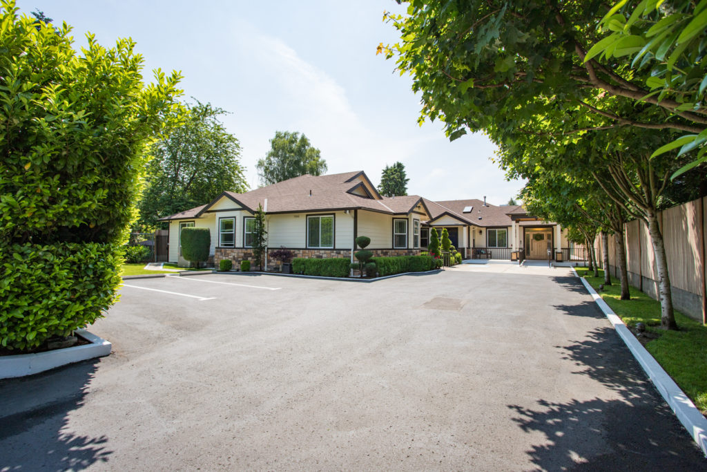 Exterior view of Mapleview Manor with landscaped area