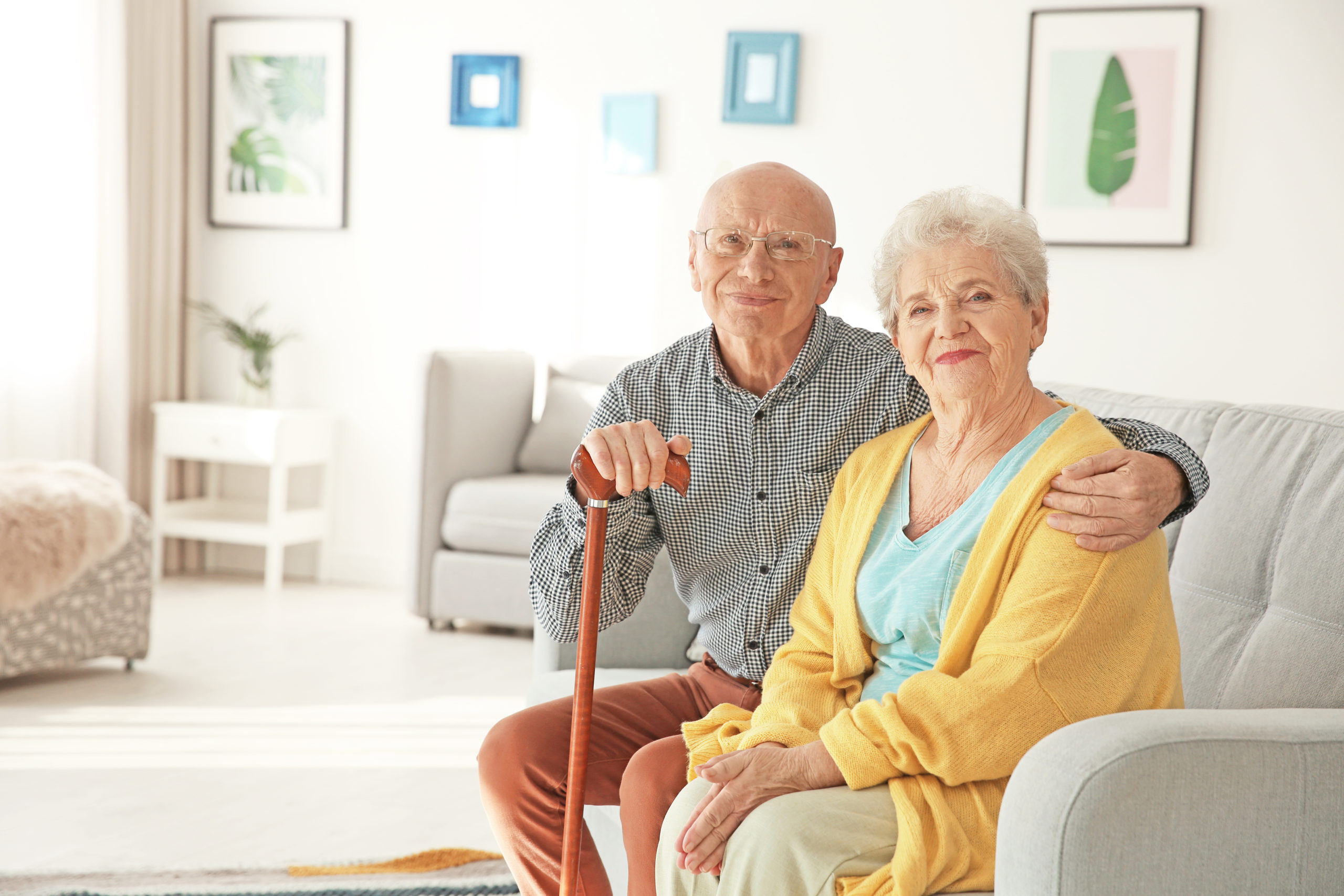 Senior couple sitting together in a cozy living room.