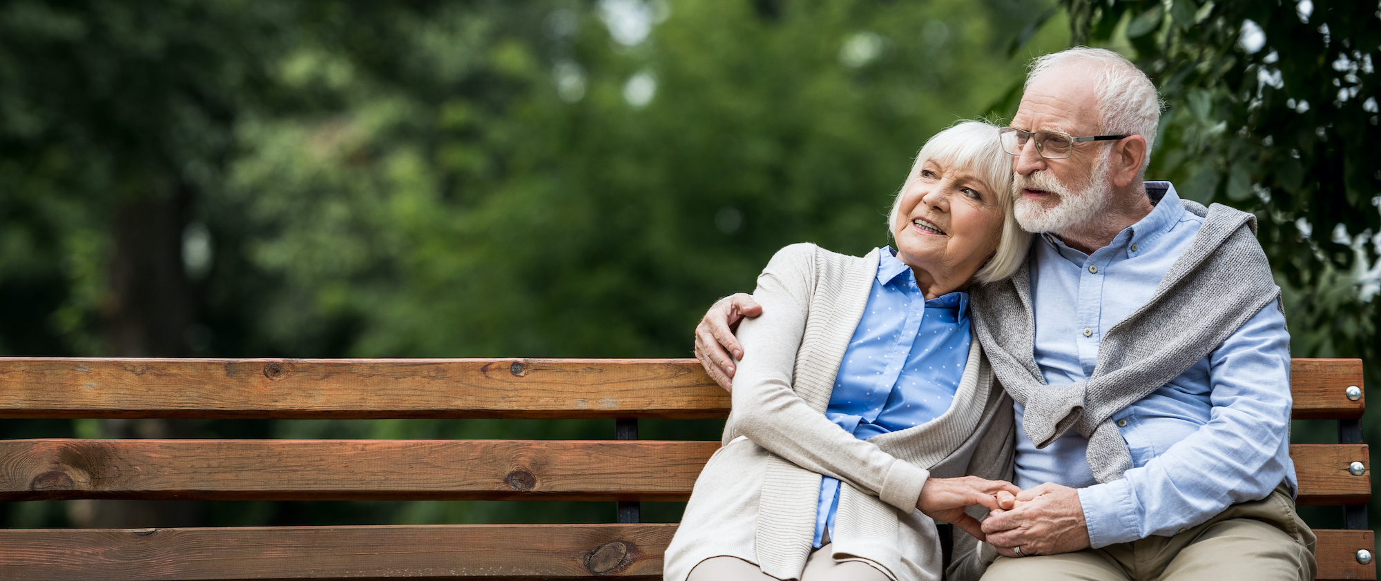 Senior couple enjoying time outside on a bench