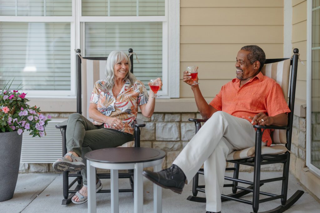 Two residents enjoying drinks on a porch.