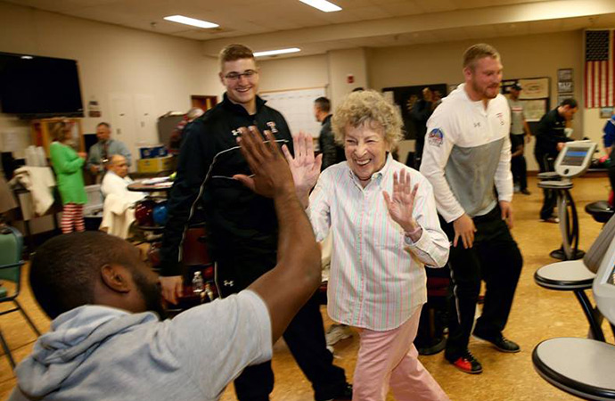 Residents engaging in an activity with staff members.