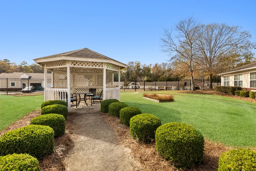 Garden gazebo surrounded by manicured hedges