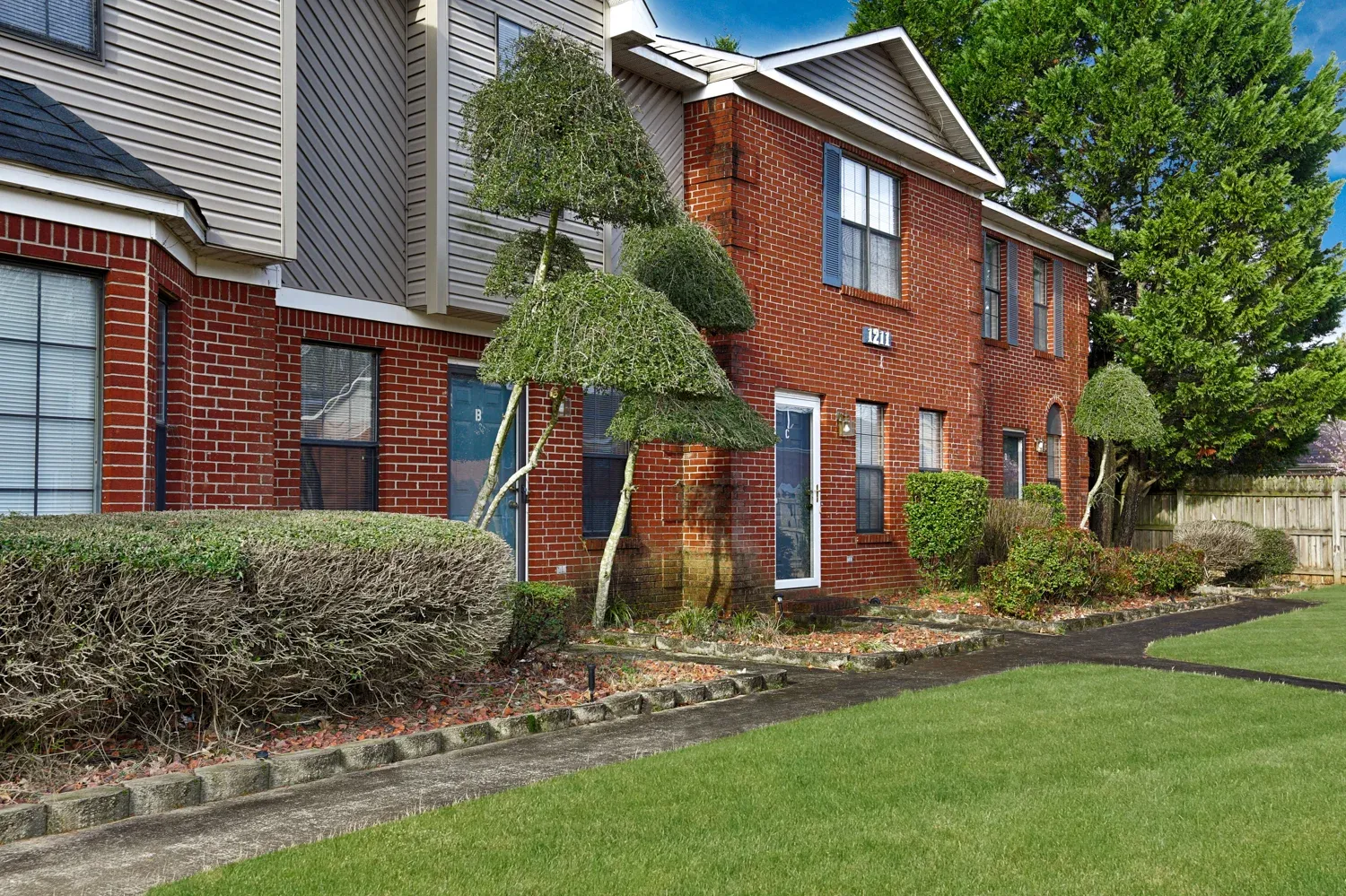 Exterior view of Huntington Place Townhomes with landscaped gardens
