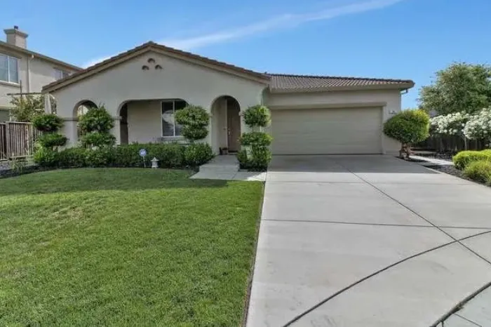 Front view of a residential building with green lawn