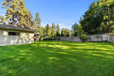 Open lawn area with well-maintained grass and trees