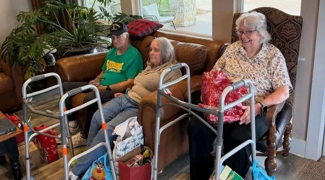 Residents sitting in a cozy common area during an event