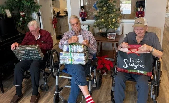Residents enjoying gift opening during a celebration