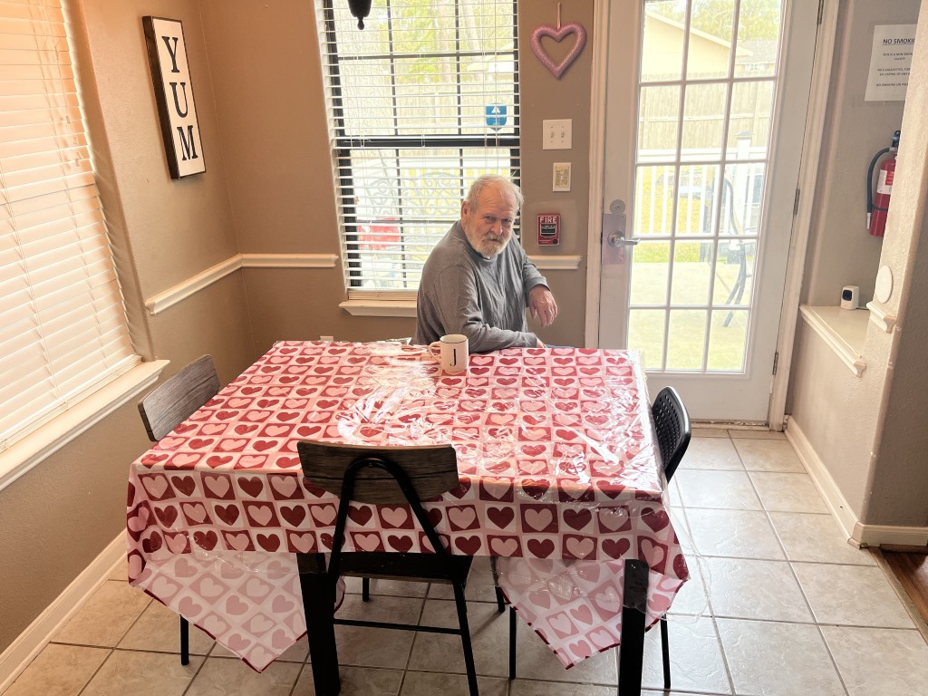 Resident sitting at a table in a cozy dining area