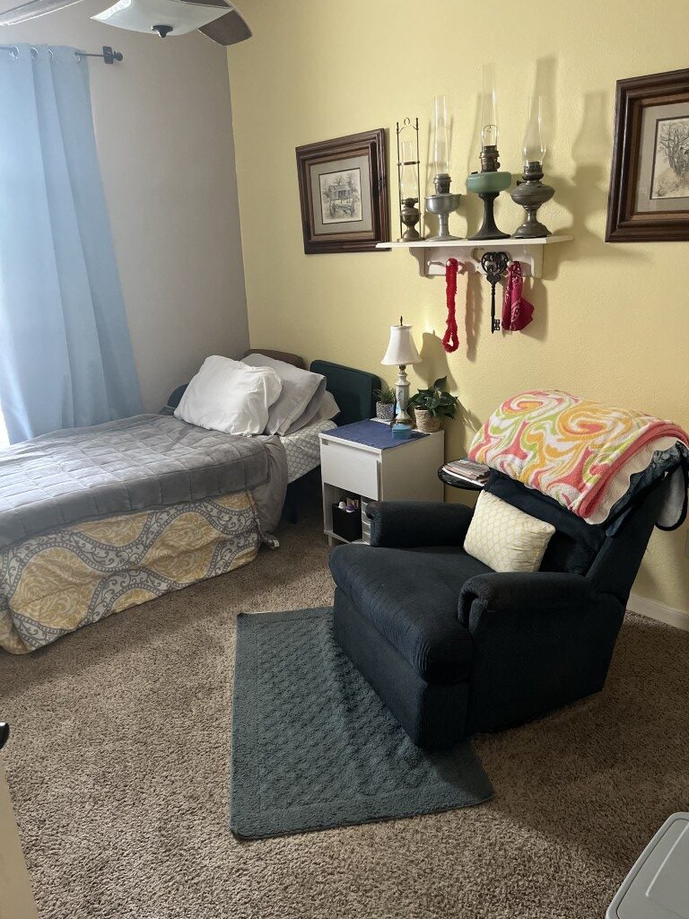 Cozy interior of a resident room with a chair and bed