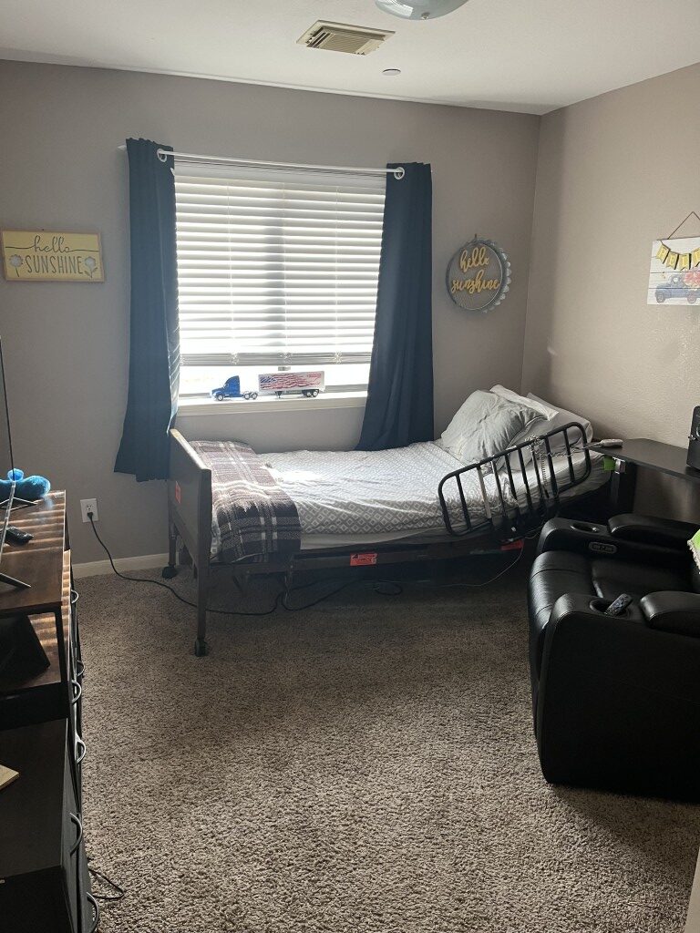 A private resident room with bed and furniture