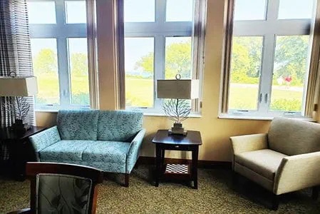 Cozy common area with seating by large windows