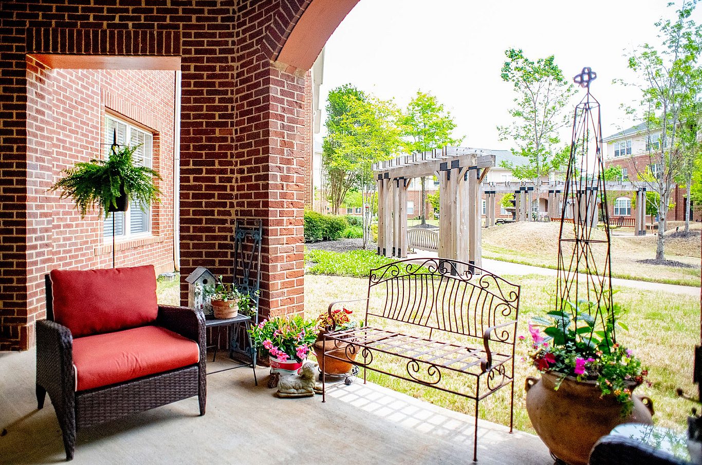 Outdoor seating area with flowers in a senior living community