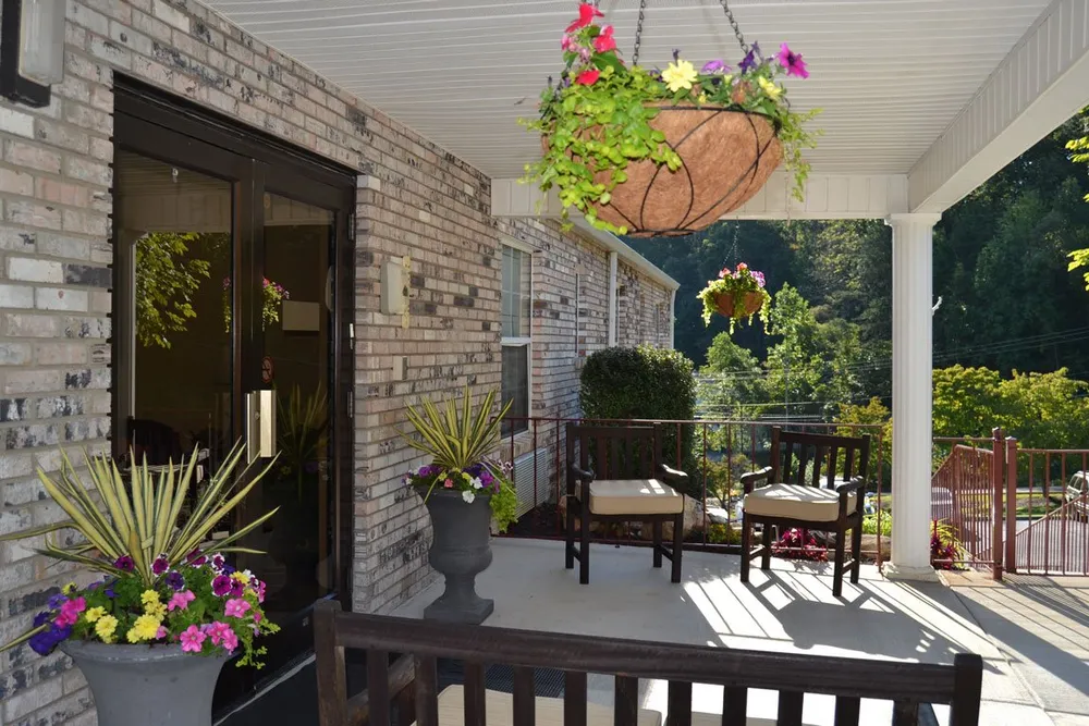 Outdoor patio area with flowers and seating