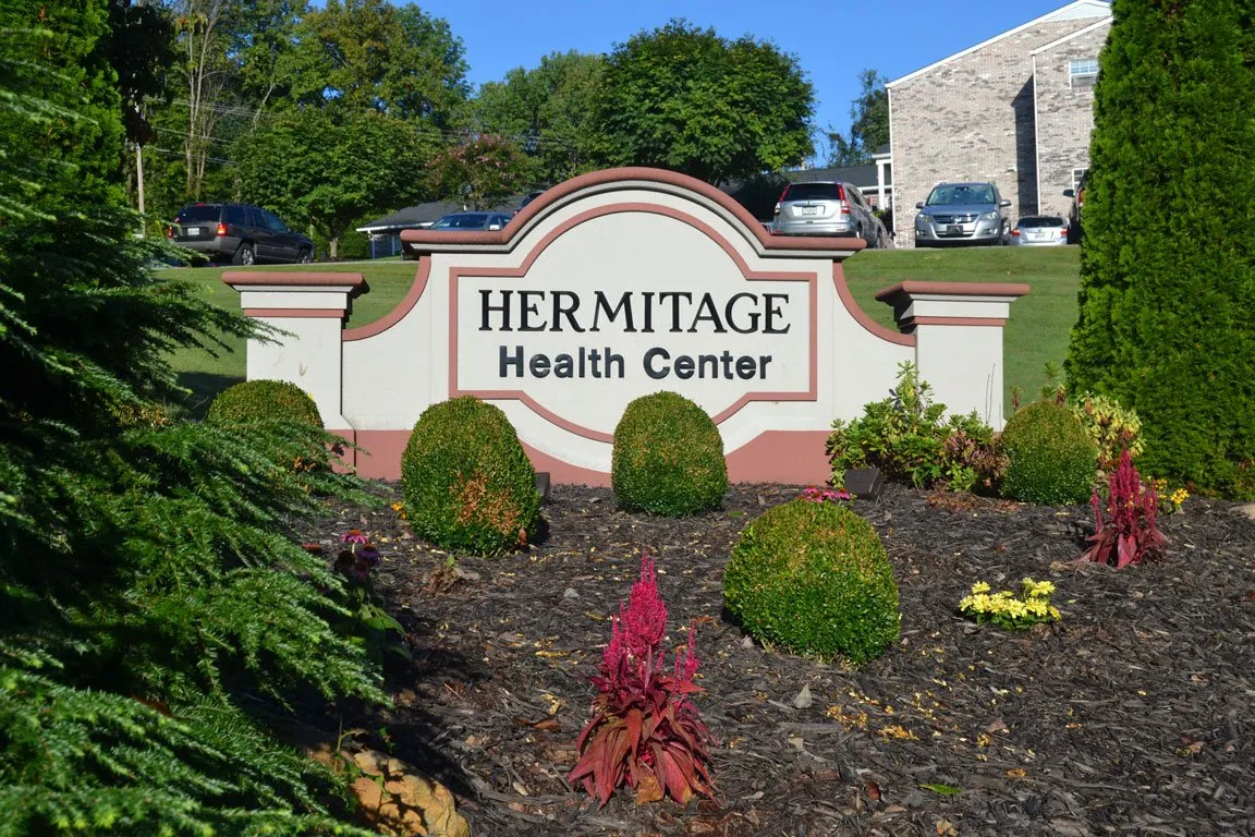 Signage for Hermitage Health Center in a landscaped area