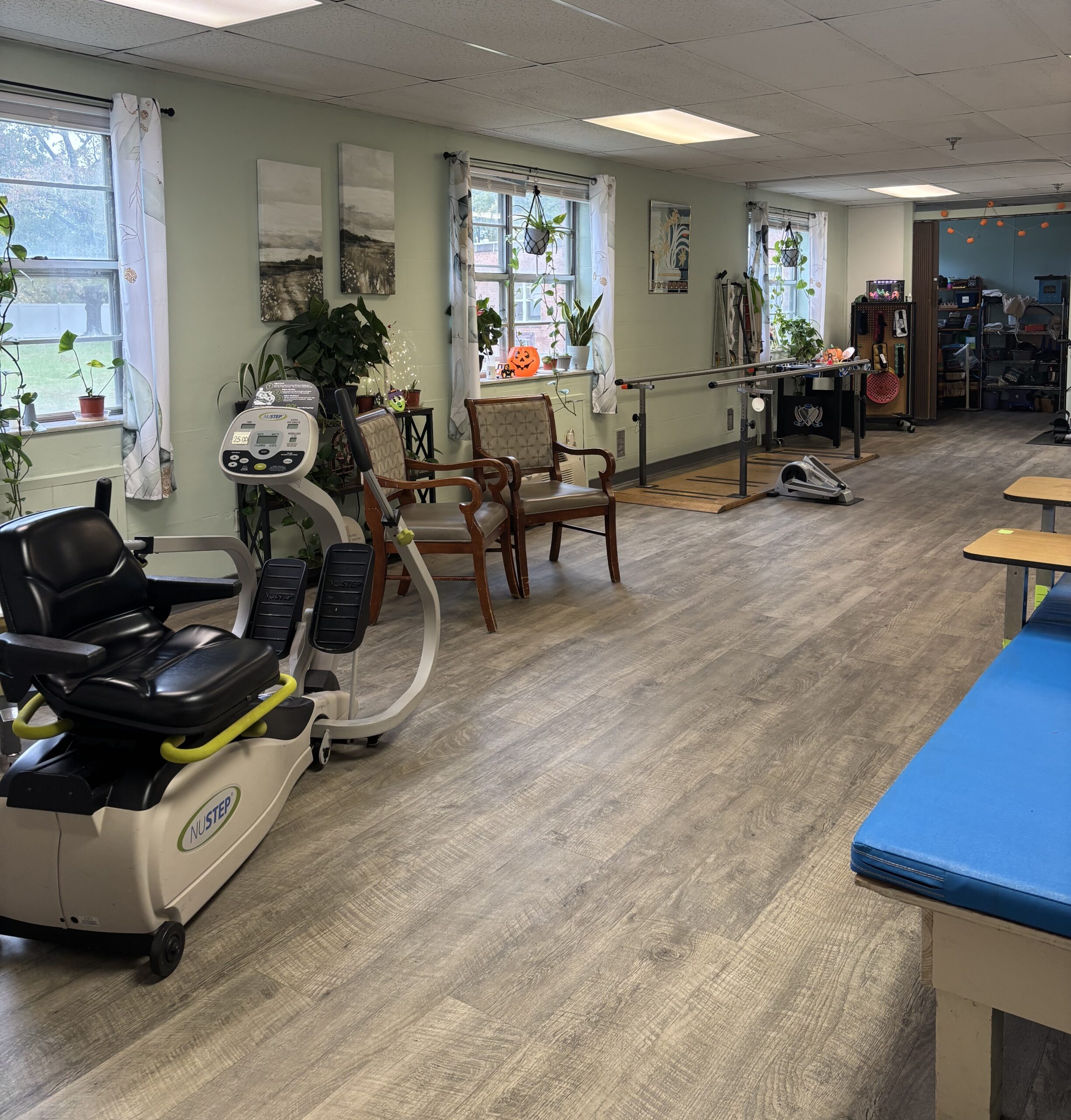 Bright activity room with rehabilitation equipment and seating