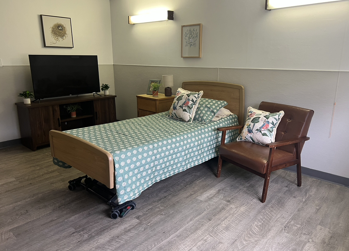 Private resident room with a bed and chair
