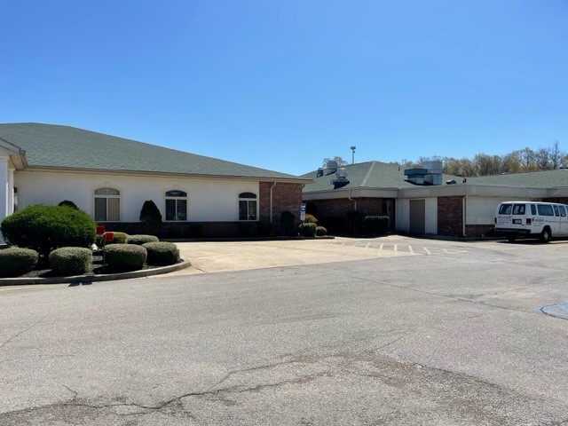 Exterior view of Oakdale Care Center with building and van