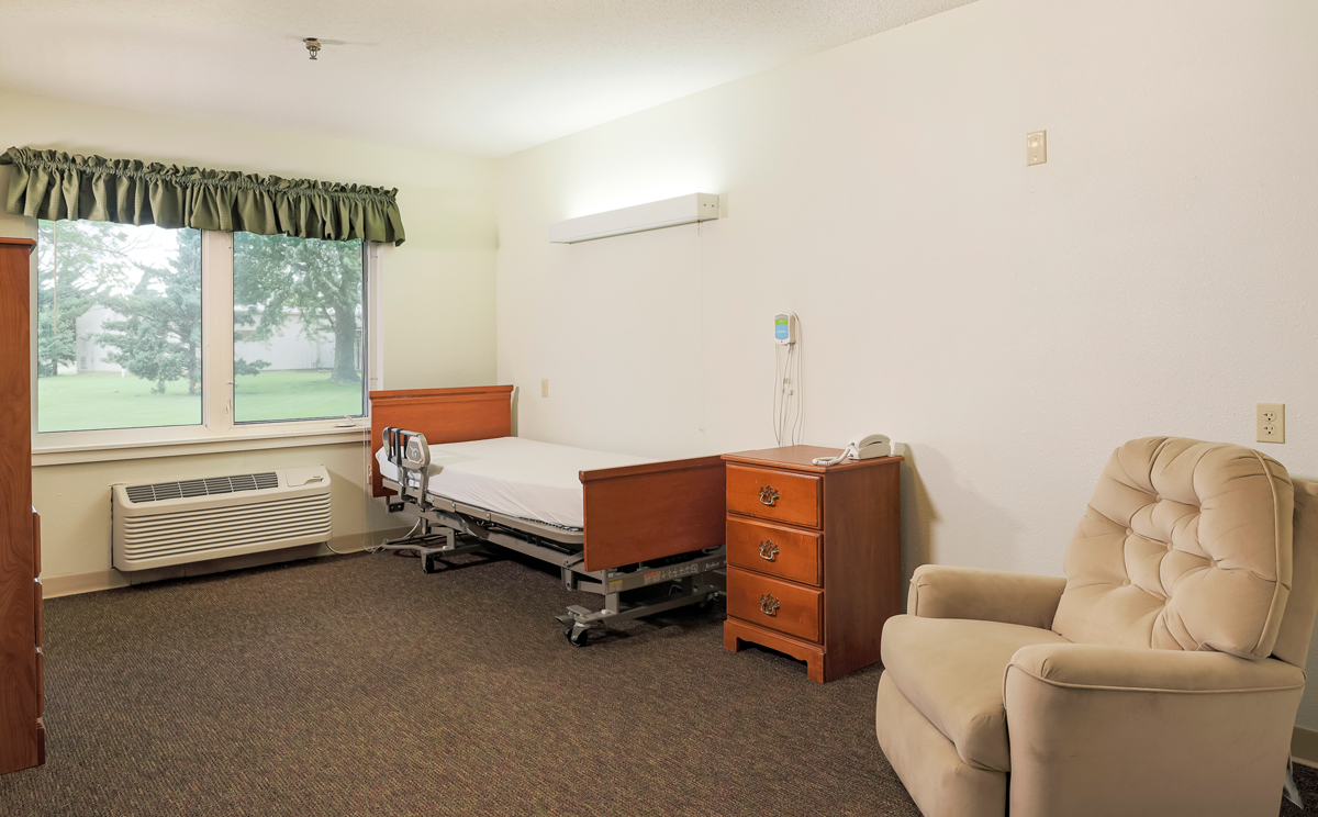 Private resident room with bed and chair