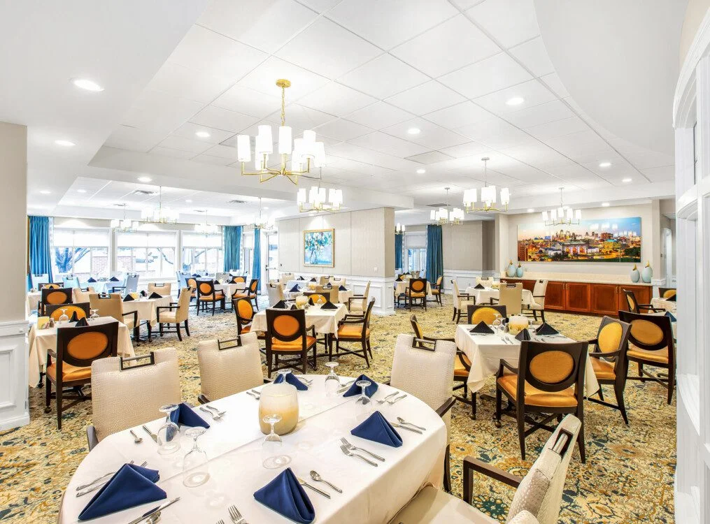 Bright dining room with elegantly set tables.
