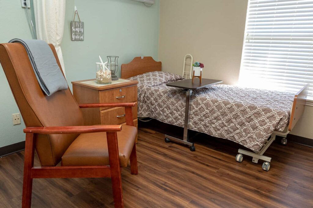 Cozy resident room with a bed and armchair