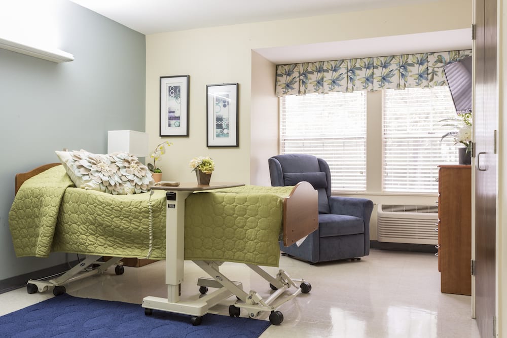 Private resident room with a bed and chair