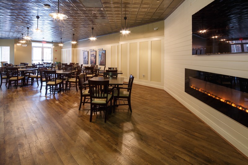 Interior view of a dining room with wooden tables and chairs