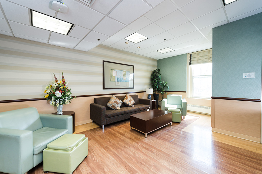 Bright common area with seating and floral arrangement