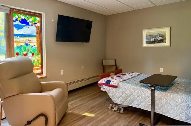 Cozy resident room with a quilt and TV
