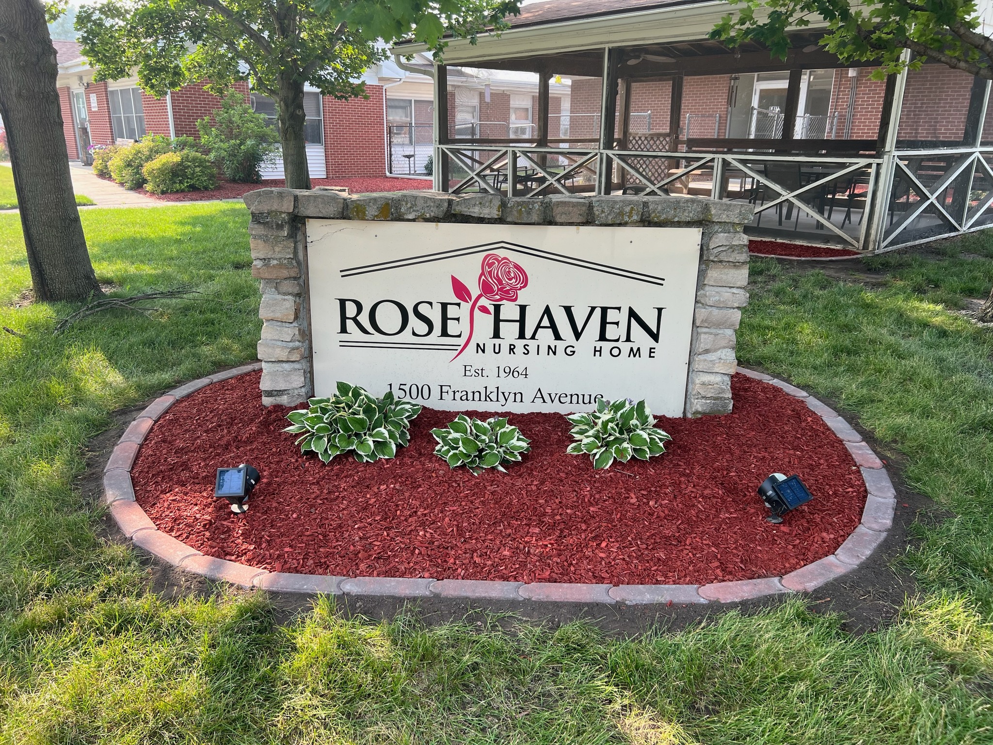 Exterior sign of Rose Haven Nursing Home with landscaping