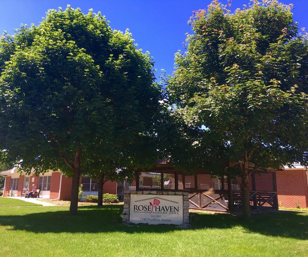 Exterior view of Rose Haven Nursing Home with trees