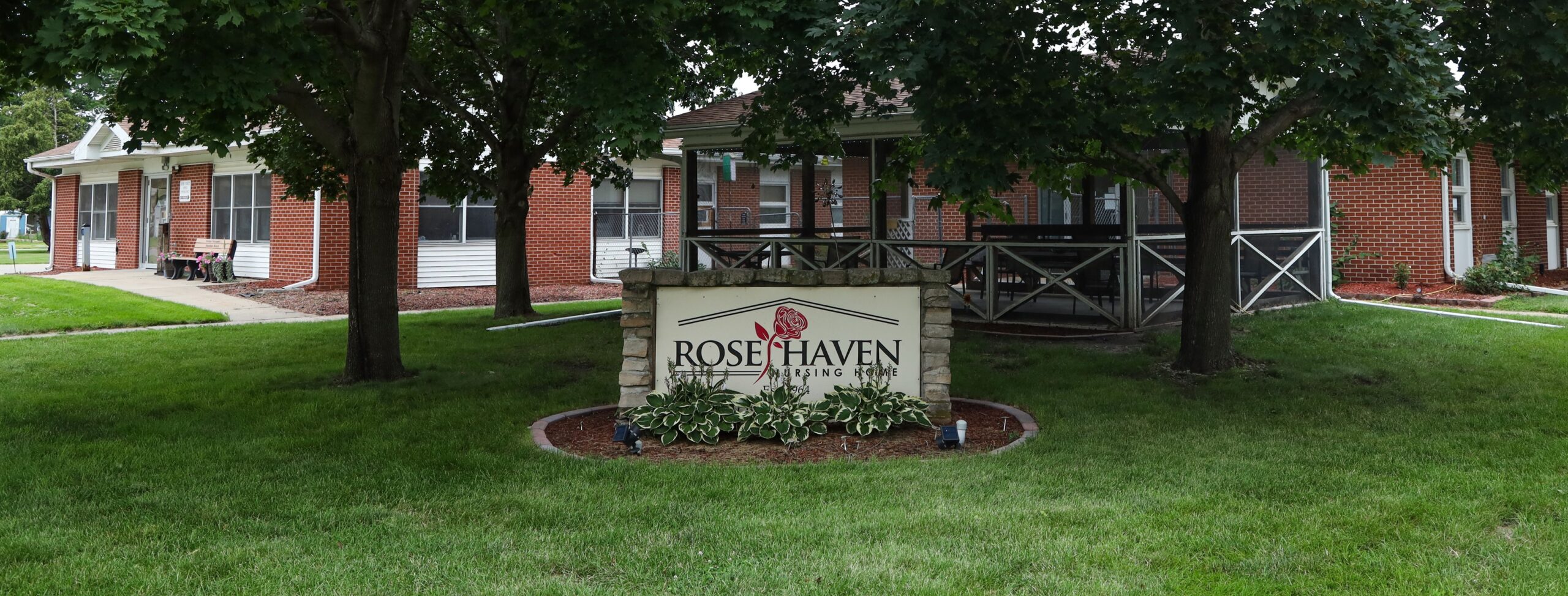 Exterior view of Rose Haven Nursing Home sign and building