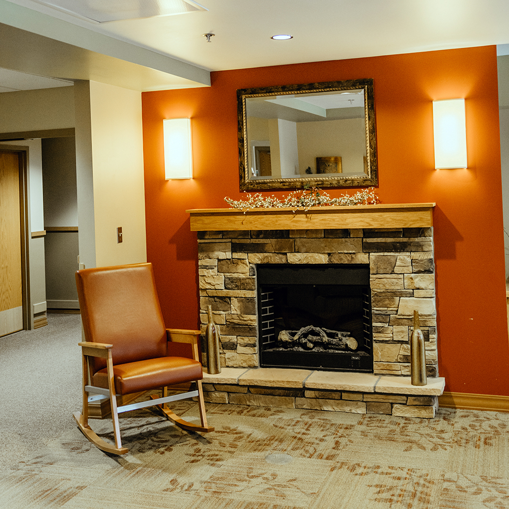 Cozy common area with a fireplace and rocking chair