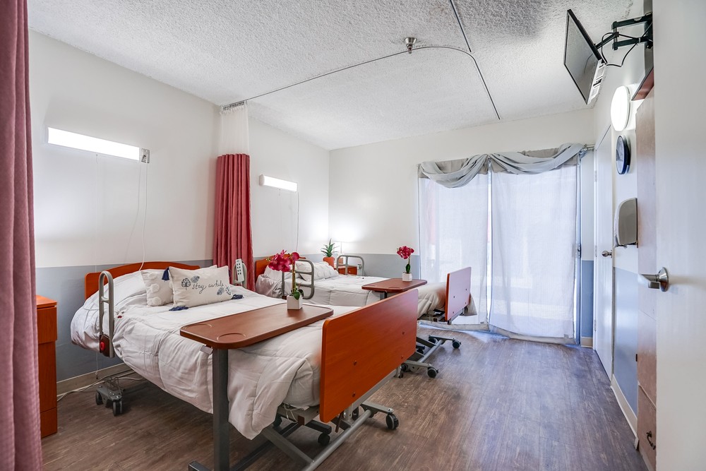 Private resident room with two beds and natural light