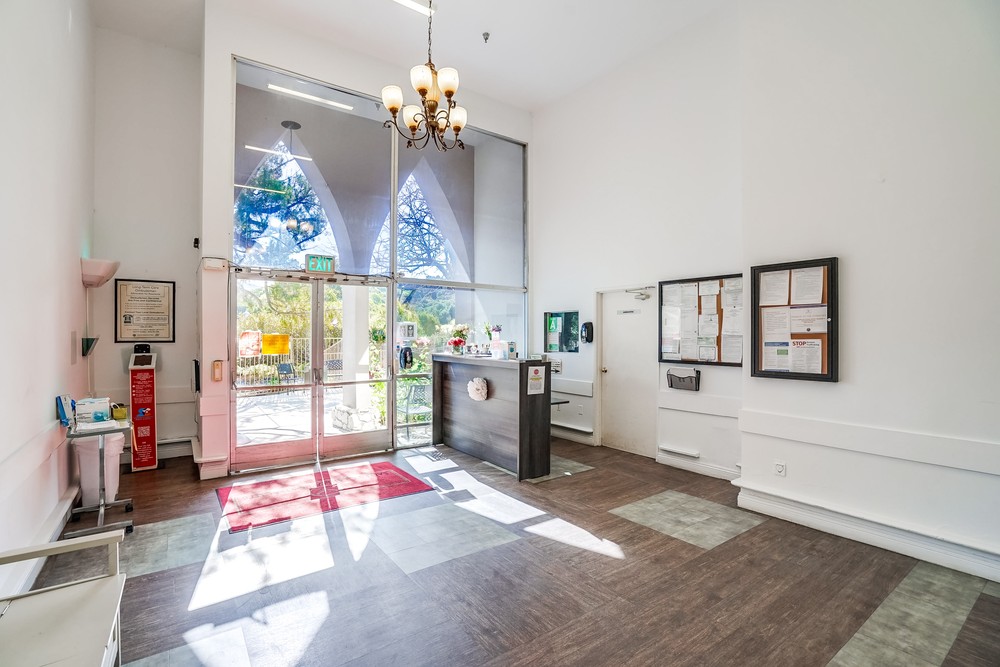 Bright interior lobby with large windows and reception desk