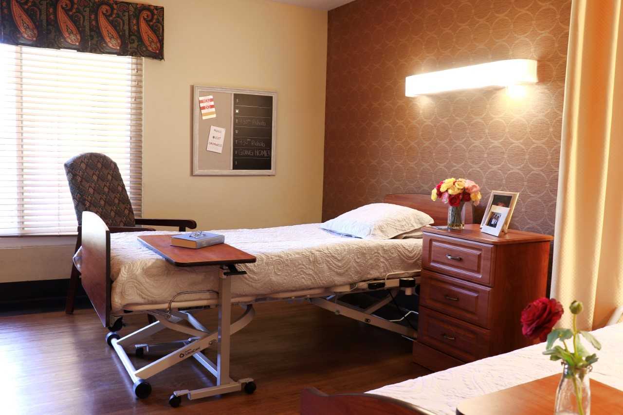 Cozy resident room with a bed and chair