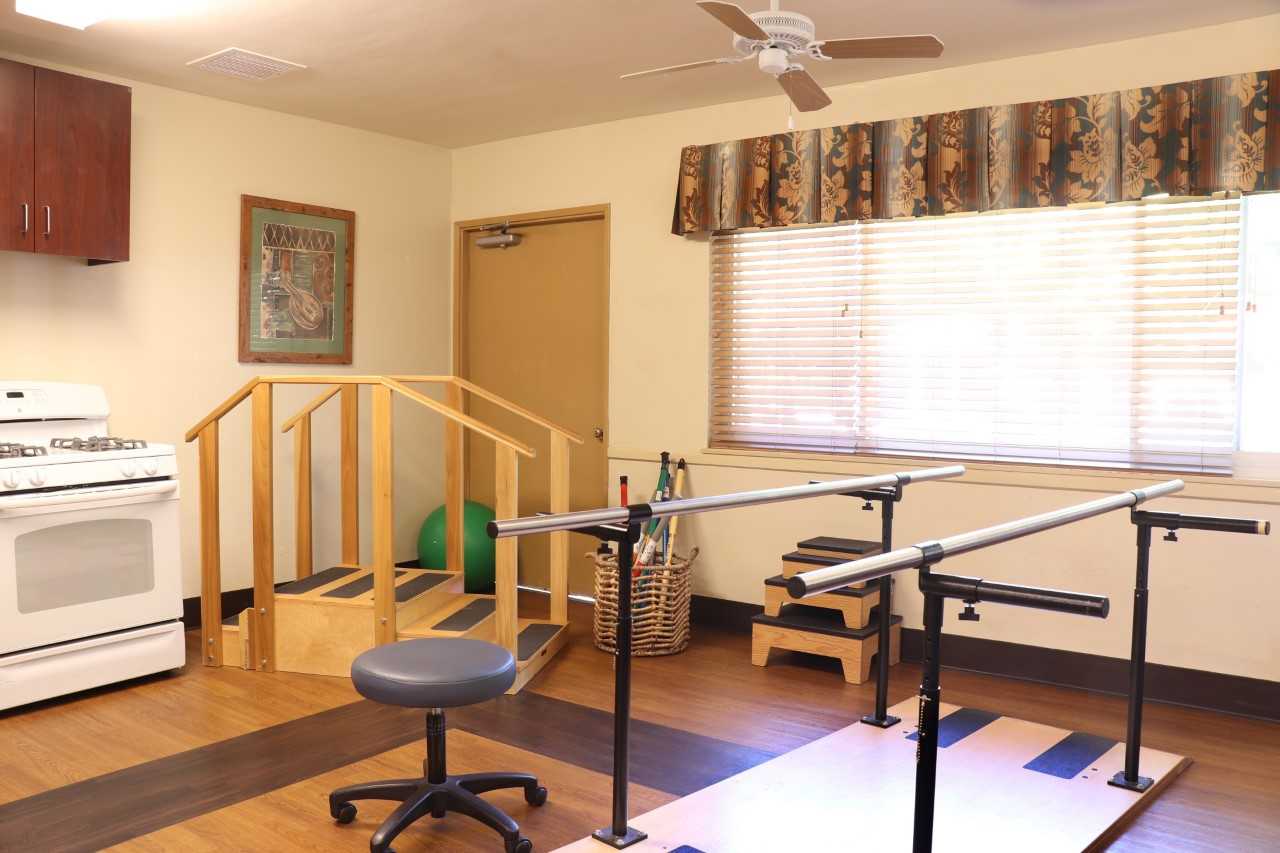 Physical therapy room with equipment and a kitchenette