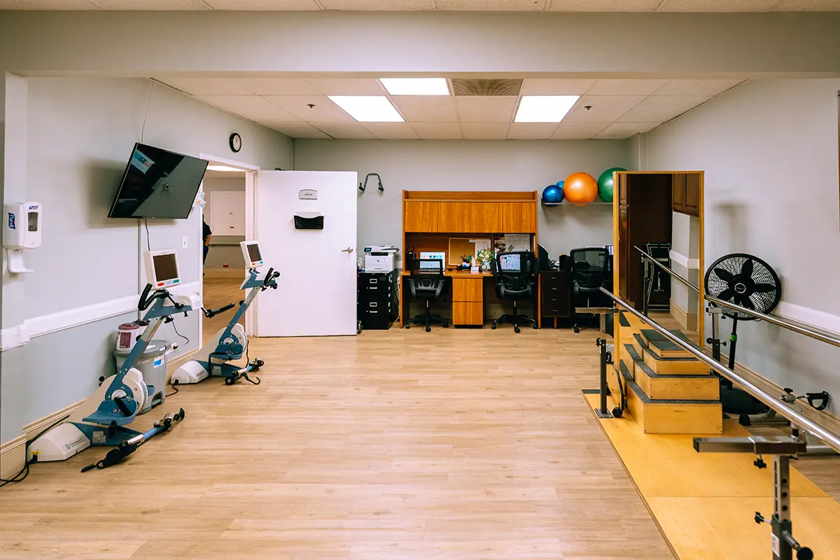 A physical therapy room with exercise equipment