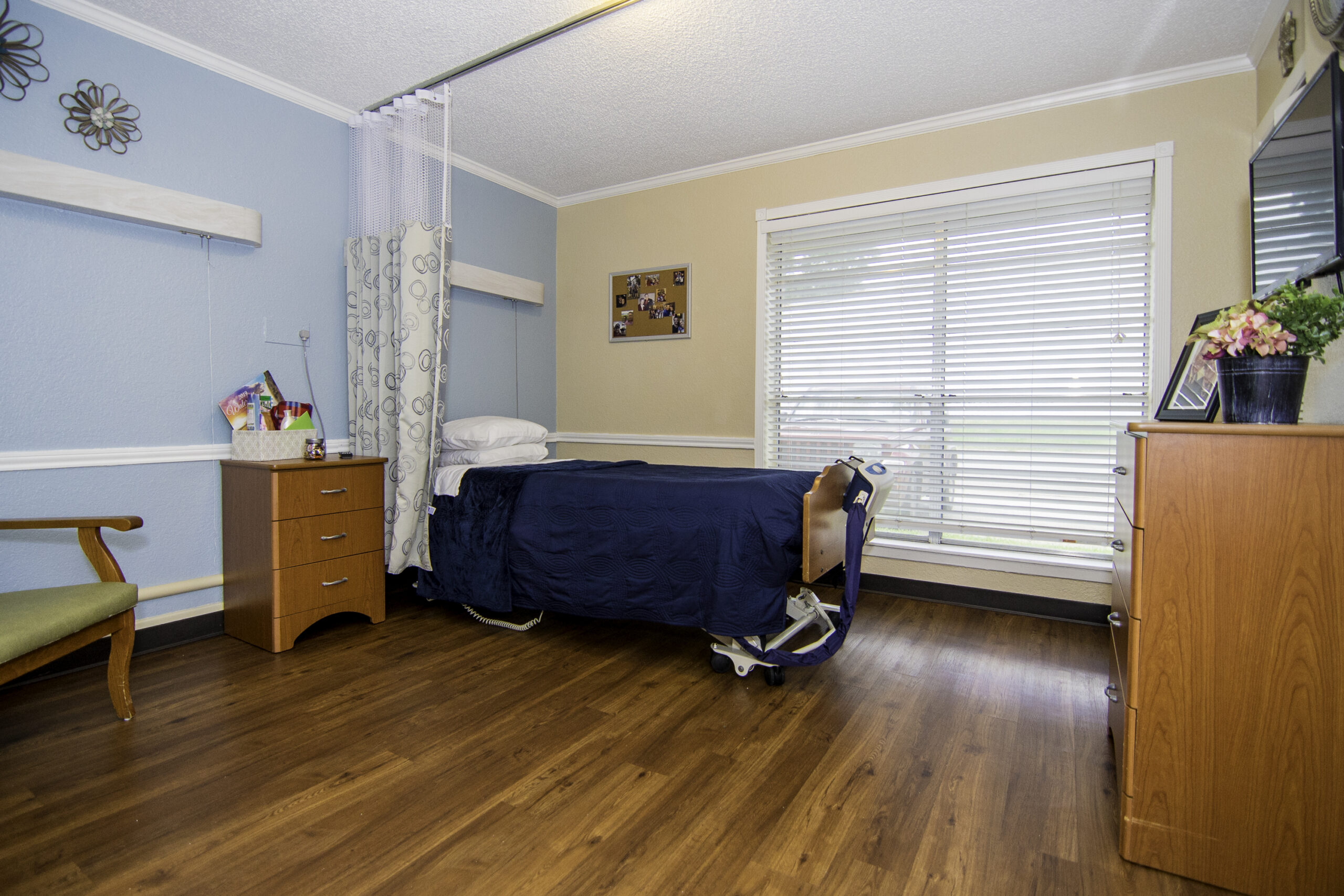 Cozy private resident room with wooden floor and natural light