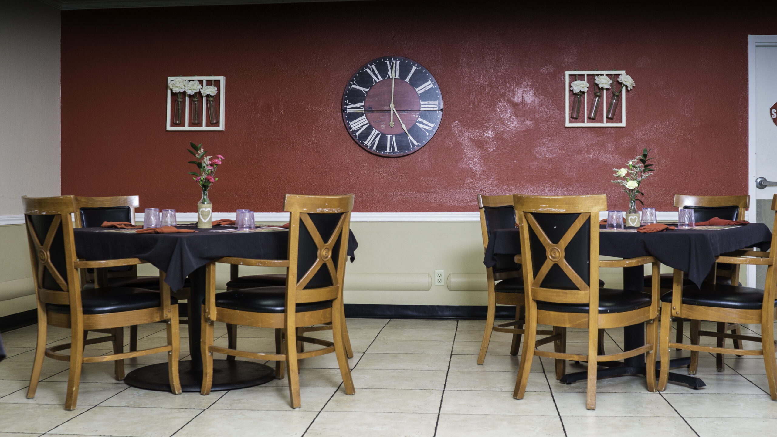 Dining area with wooden tables and decorative wall