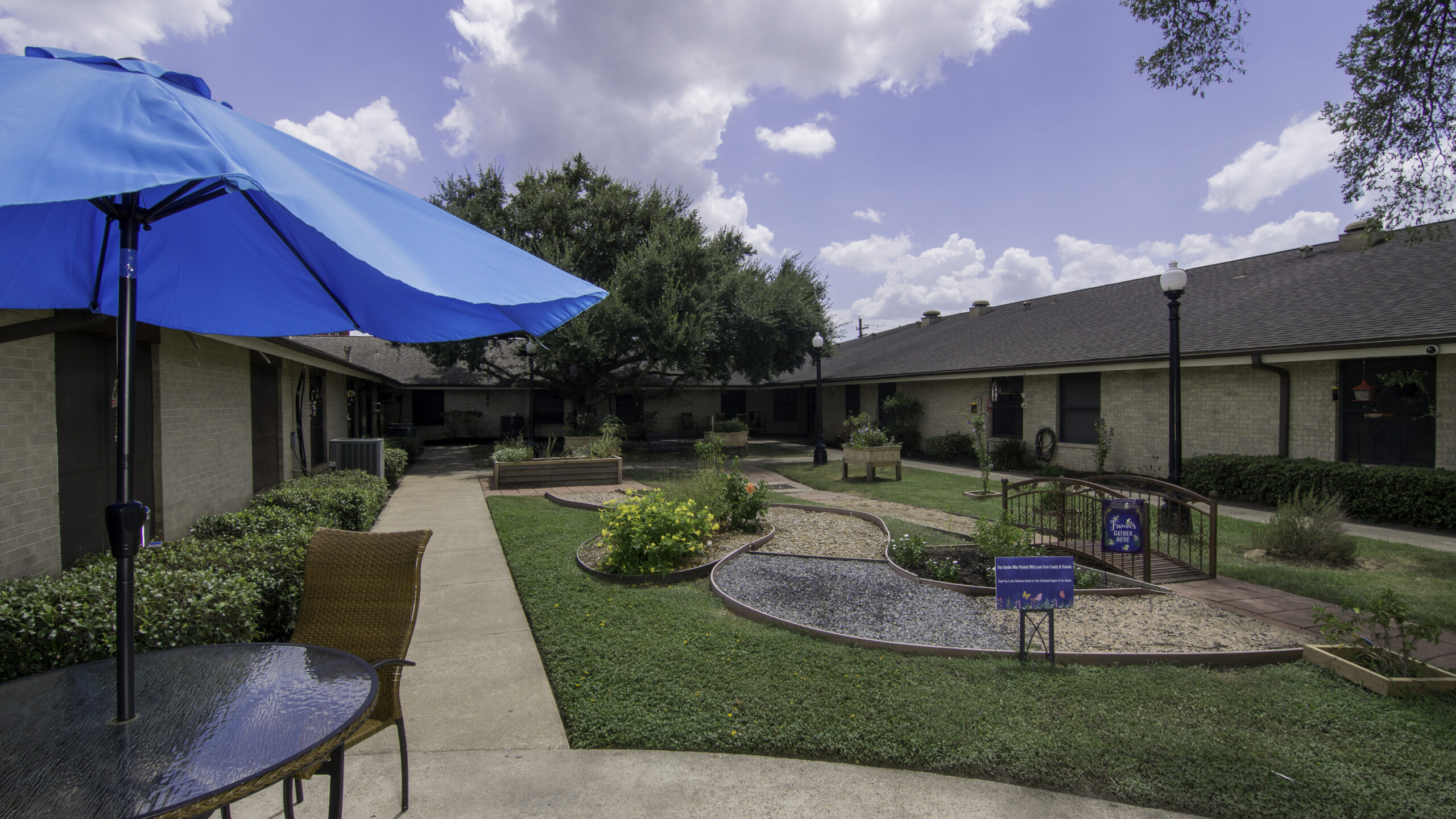 Outdoor garden space with seating and blue umbrella